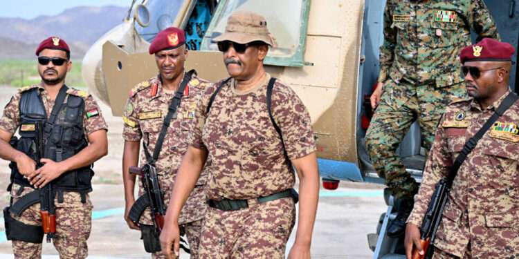 Sudan's army chief Abdel Fattah al-Burhan (C) arrives at a graduation ceremony in Gibet near Port Sudan on July 31, 2024.