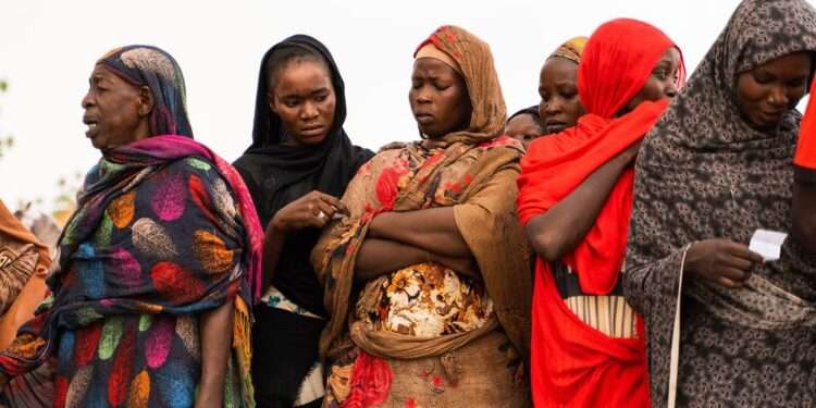 Women waiting for aid distribution in Wad Madani, Sudan.