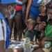 Haiti Faces Escalating Crisis Amid Humanitarian Funding Shortfall 11 A UN staff member provides medical care to a displaced woman and children.