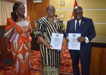 The President of Ghana with Hon. Lydia Seyram Alhassan, Minister for Sanitation and Water Resources and the UN in Ghana Delegate show the signed Presidential Compact on WASH.