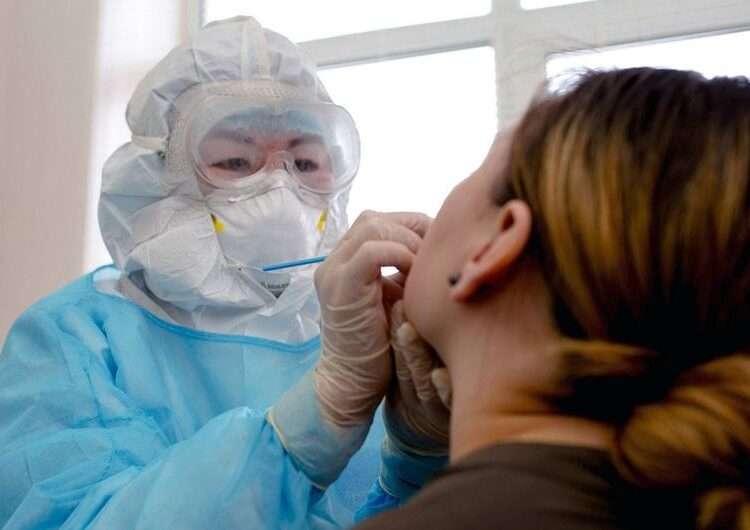 A woman is tested for COVID-19