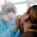 A woman is tested for COVID-19