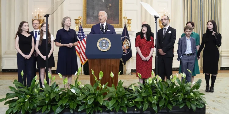 President Joe Biden, center, delivers remarks on a prisoner swap with Russia from the State Dining Room of the White House, Thursday, Aug. 1, 2024, in Washington.