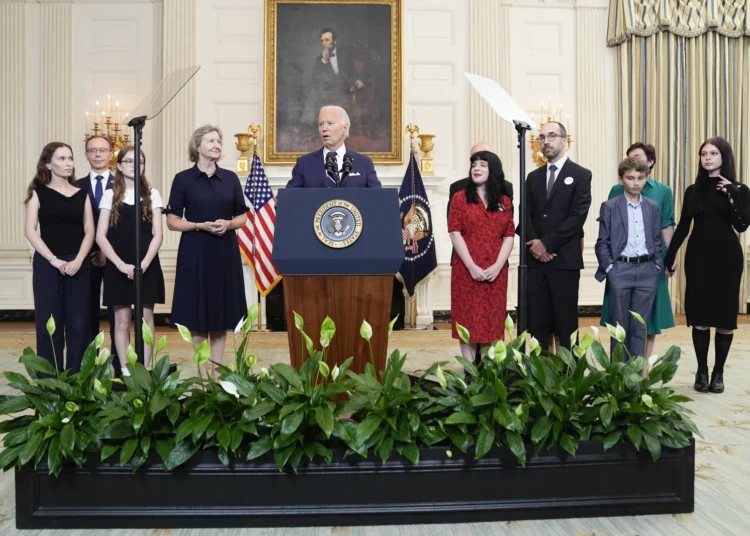 President Joe Biden, center, delivers remarks on a prisoner swap with Russia from the State Dining Room of the White House, Thursday, Aug. 1, 2024, in Washington.