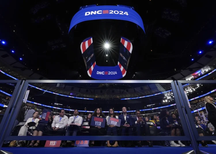 The Obamas To Address Crowd On DNC Second Day 1 Delegates watch during the DNC on Monday, August 19, 2024.