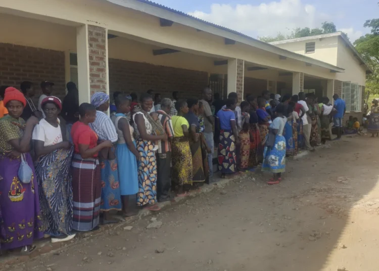 Malawi Receives $11.2M Insurance Payout Amid Drought Crisis 1 People queue for food at a World Food Programme distribution center in Neno district southern Malawi