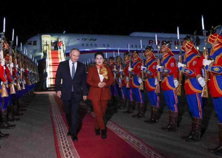 Putin Lands In Mongolia 1 Russia's President Vladimir Putin, accompanied by Battsetseg Batmunkh, Mongolia's Minister of Foreign Affairs, walks past honour guards upon arrival at the airport in Ulaanbaatar.