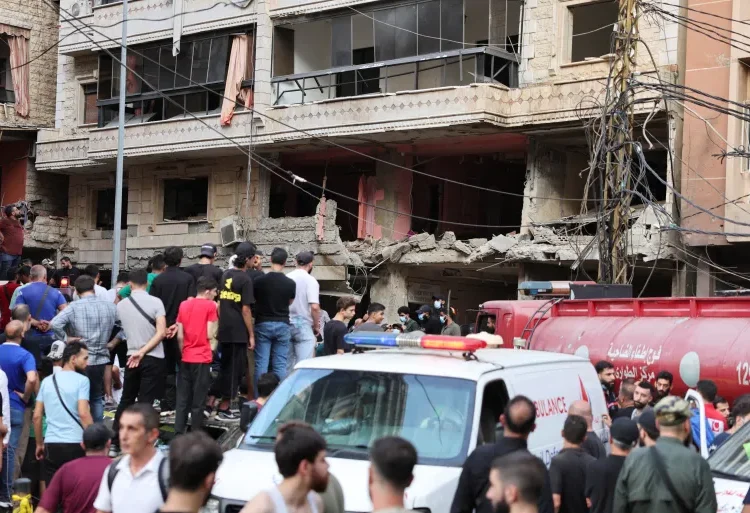People inspect the site of an Israeli strike in the southern suburbs of Beirut, September 20, 2024.