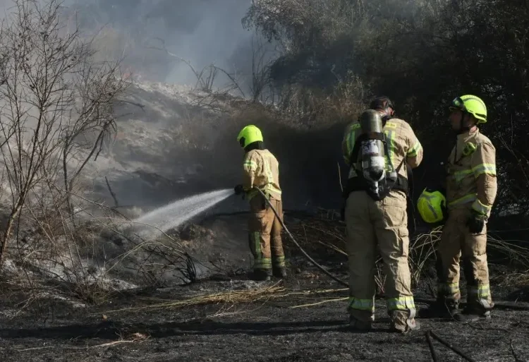 Responders put out a fire in the area of Lod, near Tel Aviv, in central Israel on September 15, 2024.