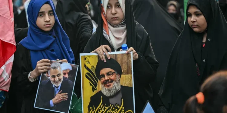 Three girls take part in a protest march to condemn the killing of Hassan Nasrallah, late leader of the Lebanese group Hezbollah, in Islamabad, Pakistan on September 29, 2024.