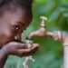 Drinking with Suspicion: Richard Nyarko documents Declining Water Quality 12 Clean Fresh Water Scarcity Symbol: Black Girl Drinking from Tap.