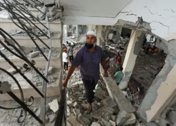 Israel Escalates Military Operations On Two Fronts 3 Palestinians inspect the site of mosque hit in Israeli airstrike.