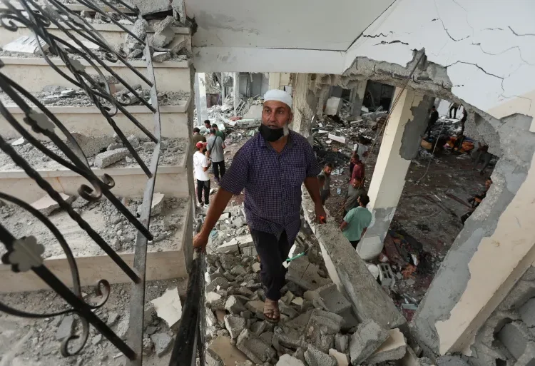 Israel Escalates Military Operations On Two Fronts 1 Palestinians inspect the site of mosque hit in Israeli airstrike.