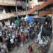 Palestinians inspect the site of an Israeli strike on a school sheltering displaced people in Deir Al-Balah.
