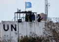 Members of the United Nations peacekeepers (UNIFIL) look at the Lebanon-Israel border, as they stand on the roof of a watch tower ‏in the town of Marwahin, in southern Lebanon, October 12, 2023.