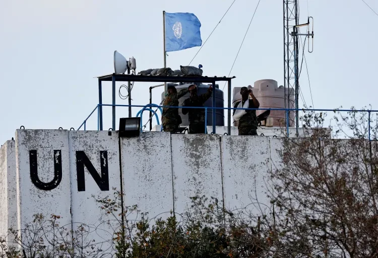 Members of the United Nations peacekeepers (UNIFIL) look at the Lebanon-Israel border, as they stand on the roof of a watch tower ‏in the town of Marwahin, in southern Lebanon, October 12, 2023.