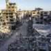 Northern Gaza Cut off From Aid 14 Palestinians are seen on a street between buildings destroyed in Israeli strikes in the northern Gaza Strip city of Jabalia, on Oct. 6, 2024.