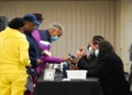 People sign in to cast their votes on the first day of early voting at East Point First Mallalieu United Methodist Church in Atlanta, Georgia.