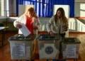 Two ladies cast their ballots.