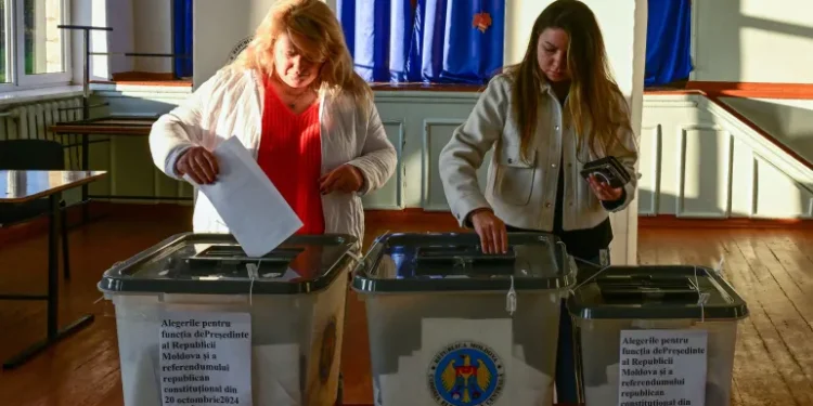 Two ladies cast their ballots.