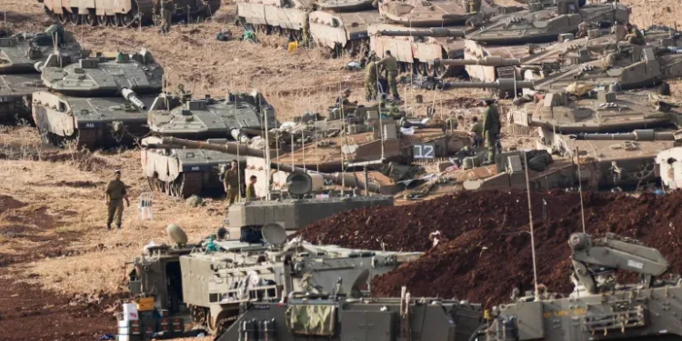 Israeli soldiers work on tanks at a staging area in northern Israel near the Israel-Lebanon border.