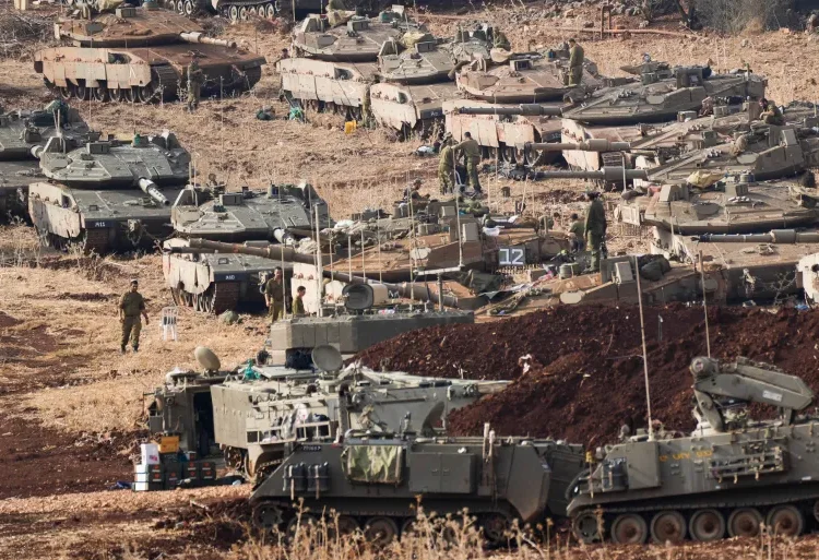 Hezbollah Demands Israeli Forces Complete Withdrawal From Lebanon 1 Israeli soldiers work on tanks at a staging area in northern Israel near the Israel-Lebanon border.