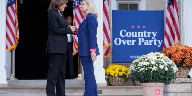 Vice President Kamala Harris, left, shakes hands with former Congresswoman Liz Cheney in Ripon, Wisconsin.