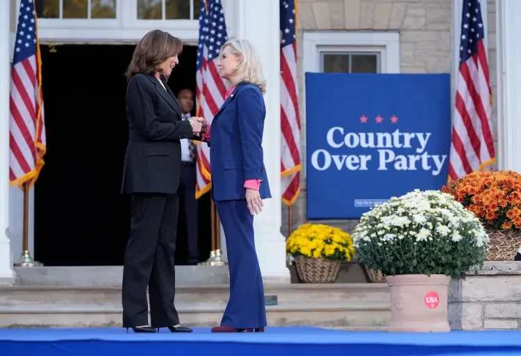 Vice President Kamala Harris, left, shakes hands with former Congresswoman Liz Cheney in Ripon, Wisconsin.