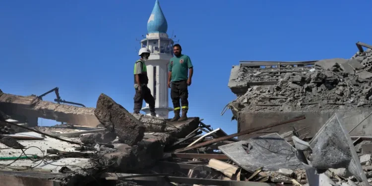 Rescue workers survey destroyed buildings in Nabatieh town, south Lebanon.
