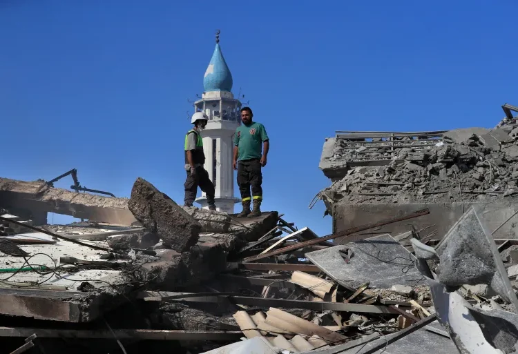 World Bank Announces 'Emergency Response' For Lebanon 1 Rescue workers survey destroyed buildings in Nabatieh town, south Lebanon.