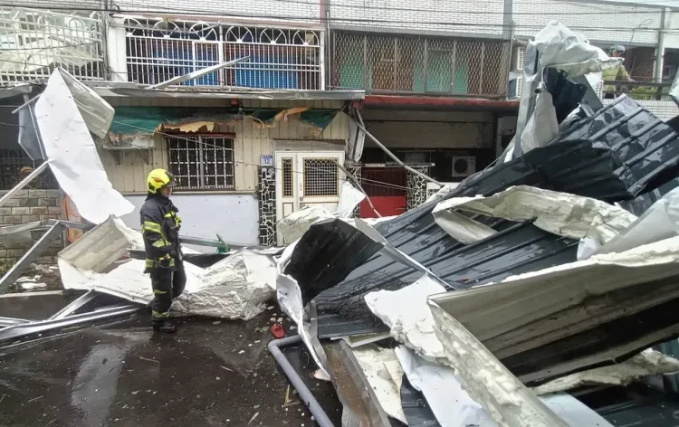 Police check on roofing destroyed by the winds of Typhoon Kong-rey in Hualien County, eastern Taiwan, on Thursday, October 31, 2024.