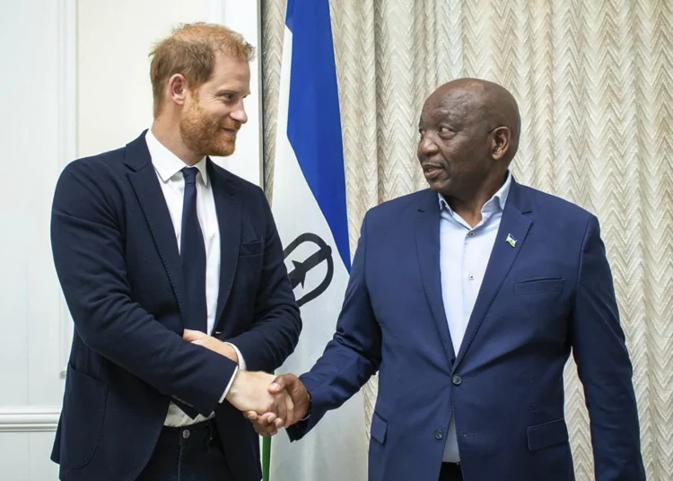 Britain's Prince Harry left, shakes hands with Lesotho's Prime Minister Sam Matekane