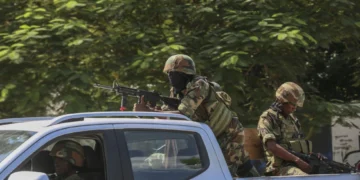 Soldiers patrol amid the sound of gunshots heard in the distance, in Port-au-Prince, Haiti