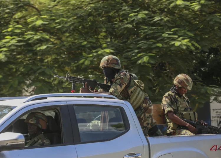 Haiti's Gangs Escalate Violence, Worsen Humanitarian Crisis 1 Soldiers patrol amid the sound of gunshots heard in the distance, in Port-au-Prince, Haiti