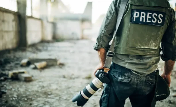 man war journalist with camera