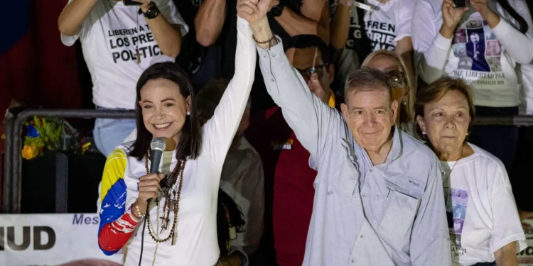 Venezuelan opposition leader María Corina Machado (L), and Venezuelan presidential candidate Edmundo González Urrutia, greet supporters at the closing of González Urrutia's campaign, in Caracas, Venezuela, 25 July 2024.