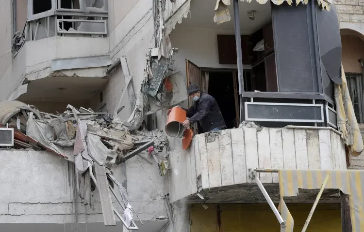 A man cleans his apartment in a damaged building in Beirut’s southern suburbs.