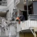 Israel-Hezbollah Ceasefire Violated 13 A man cleans his apartment in a damaged building in Beirut’s southern suburbs.