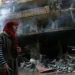 Israel-Hezbollah Ceasefire Takes Effect 13 A woman walks past a building damaged by Israeli airstrikes on Tayouneh in Beirut's suburban outskirts.