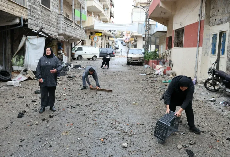 Unaddressed Issues Loom Over Israel-Hezbollah Ceasefire 1 Residents who had fled the southern Lebanese border village of Shebaa clear the debris from a street upon their return on Wednesday.