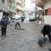 Residents who had fled the southern Lebanese border village of Shebaa clear the debris from a street upon their return on Wednesday.