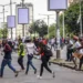 Protesters running from security forces in Maputo