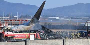 Firefighters and rescue team members work on the runway of Muan International Airport in Muan, South Korea, Sunday, Dec. 29, 2024.