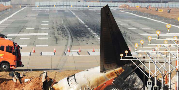 The remnants and debris of the Jeju Air passenger plane, which exploded after attempting a belly landing and colliding the previous day, remain on the runway at Muan International Airport in South Jeolla Province.