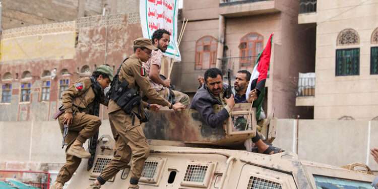 Fighters recruited into the Houthi group ride on top of an armoured personnel carrier in a demonstration to show solidarity with Palestinians in the Gaza Strip, in Sanaa, Yemen, August 24, 2024.