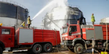 Firefighters work at the scene of an Israeli airstrike on the Haziz power station in southern Sanaa, Yemen.
