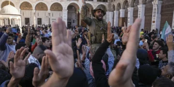 Syrians fighters and civilians chant slogans as they gather for Friday prayers at the Umayyad mosque in Damascus, Syria, Friday, Dec. 13, 2024.