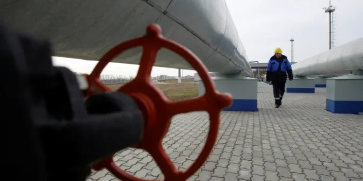 A Gazprom worker walks next to pipelines at a gas measuring station at the Russia-Ukraine border in Sudzha near Kursk.