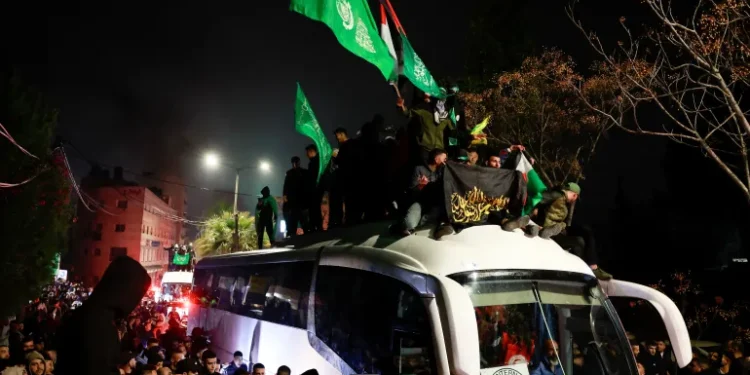 Jubilant Palestinians gather around a Red Cross bus carrying freed Palestinian prisoners after their release from an Israeli jail on January 20, 2025.