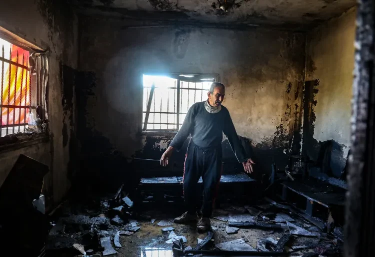 OHCHR Warns Of Intensified Attacks On Palestinians In Occupied West Bank 1 A Palestinian man inspects the damage to his house in Huwara, a town south of Nablus in the occupied West Bank, after a reported attack by Israeli settlers in December 2024.